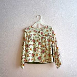 Two piece skirt with long sleeve flower shirt.